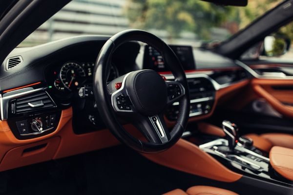 Modern supercar interior with leather panel, sport seats, multimedia and digital dashboard