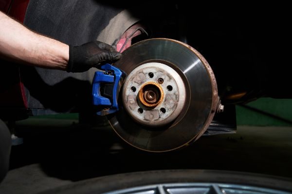 Mechanic Inspecting Vehicle Brakes